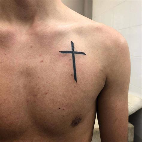 chest tattoo cross|small cross tattoo on chest.